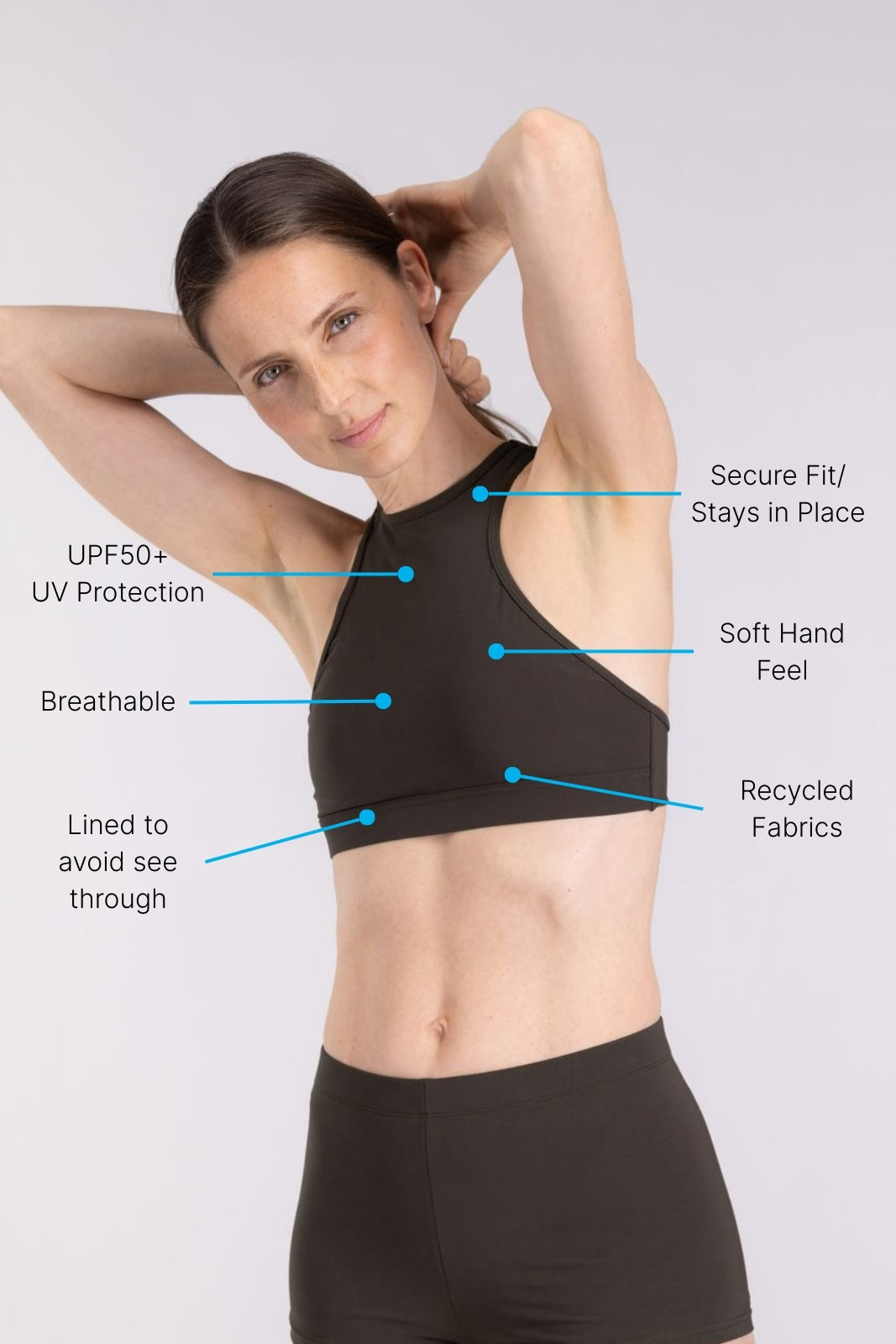 Woman in coffee racerfront tie bikini top and hot pant from WALLIEN, designed for sport and surf, in soft studio lighting