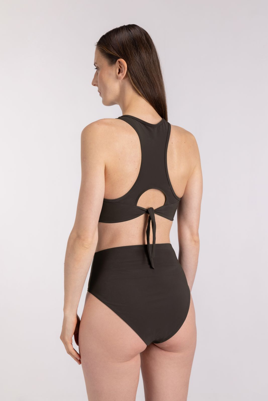 Back view of eco-friendly WALLIEN coffee Racerfront bikini, with secure tie detail and sculpted fit, light studio background