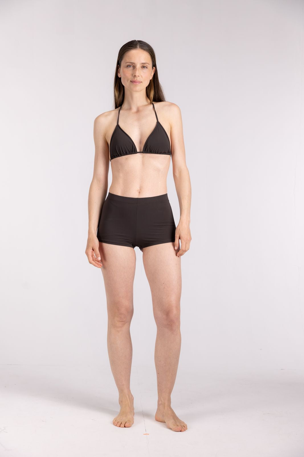 Coffee brown triangle bikini top by WALLIEN styled with hot pants, ideal for women’s surfwear, shot in studio setting