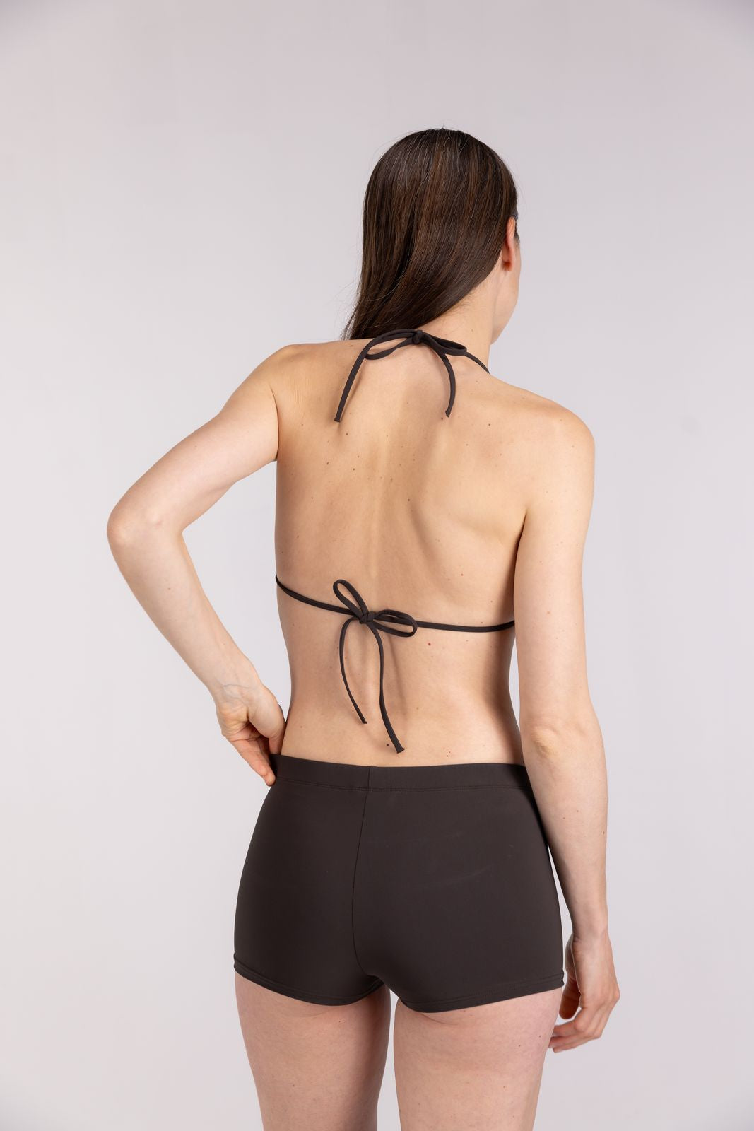 Back view of coffee triangle bikini top with tie-back straps for adjustable fit, worn in beachwear set, on studio background
