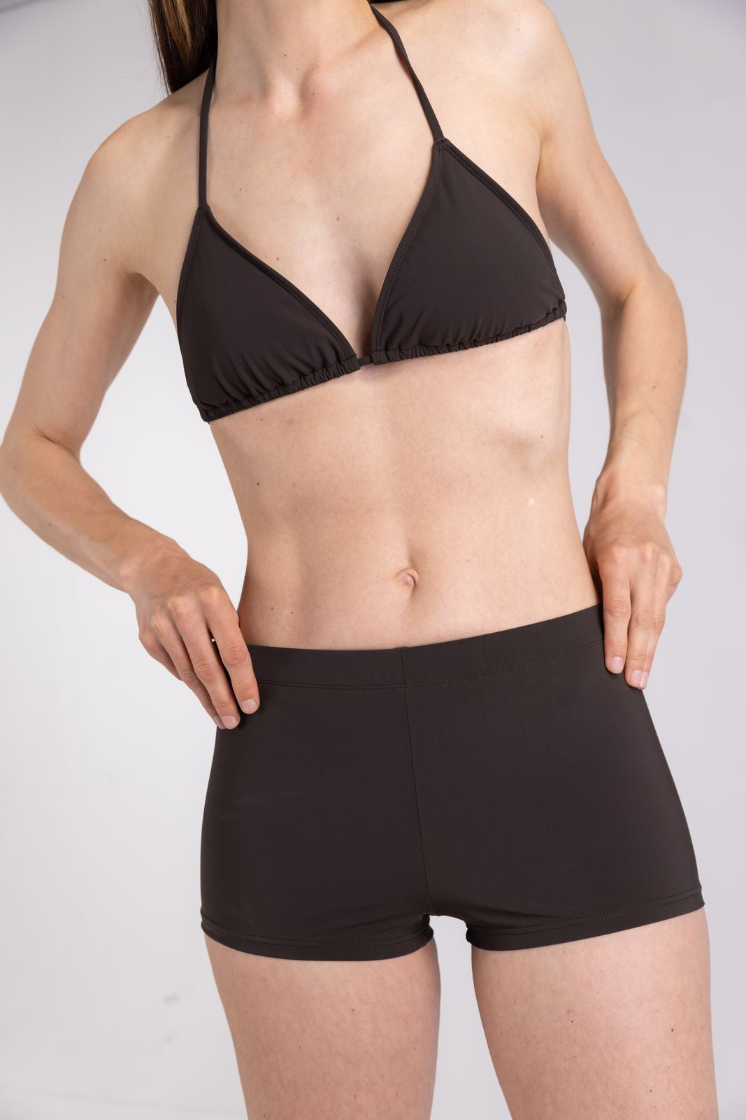 WALLIEN coffee triangle bikini top in stretch swim fabric with halter neck, styled for surfing and swimming, studio backdrop