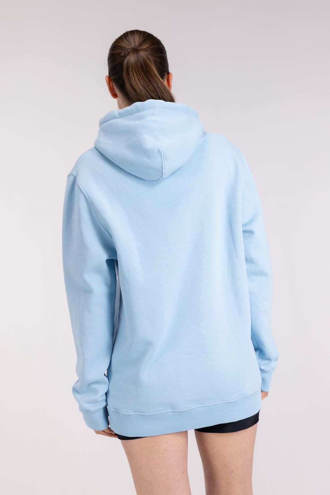 Back view of WALLIEN Ocean Hoodie in light blue, relaxed fit with soft cotton finish, shown on model against white backdrop